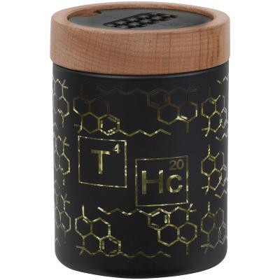 V Syndicate Smartstash Thc Elemental Yellow Small 3.5" Container, small cylindrical container with a black body decorated with gold chemical symbols and patterns, and a wooden lid.