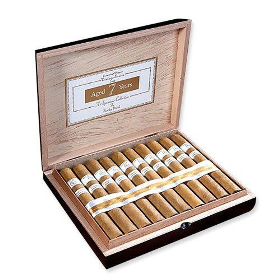 Rocky Patel Vintage 1999 Connecticut Cigars, open wooden cigar box with 20 cigars neatly arranged inside and a label indicating 7 years of aging.