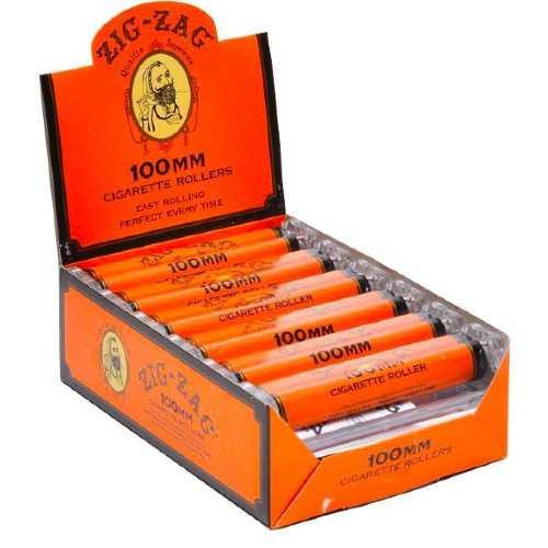 Republic Group Zig Zag Cigarette Rolling Machine 100MM, orange rolling machine with black and yellow logo, displayed inside an open orange box with multiple rolling machines arranged inside.