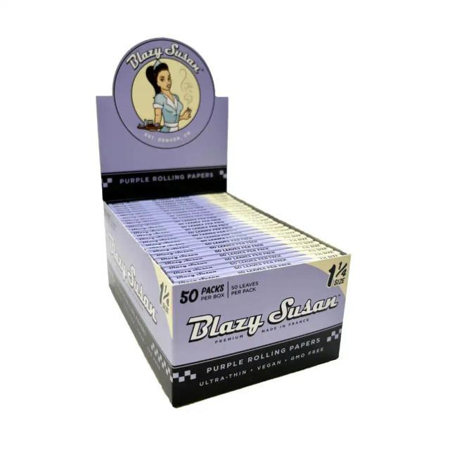 Blazy Susan Purple Rolling Paper 1 1/4 50Ct, display box filled with packs of purple rolling papers with purple and black packaging design.
