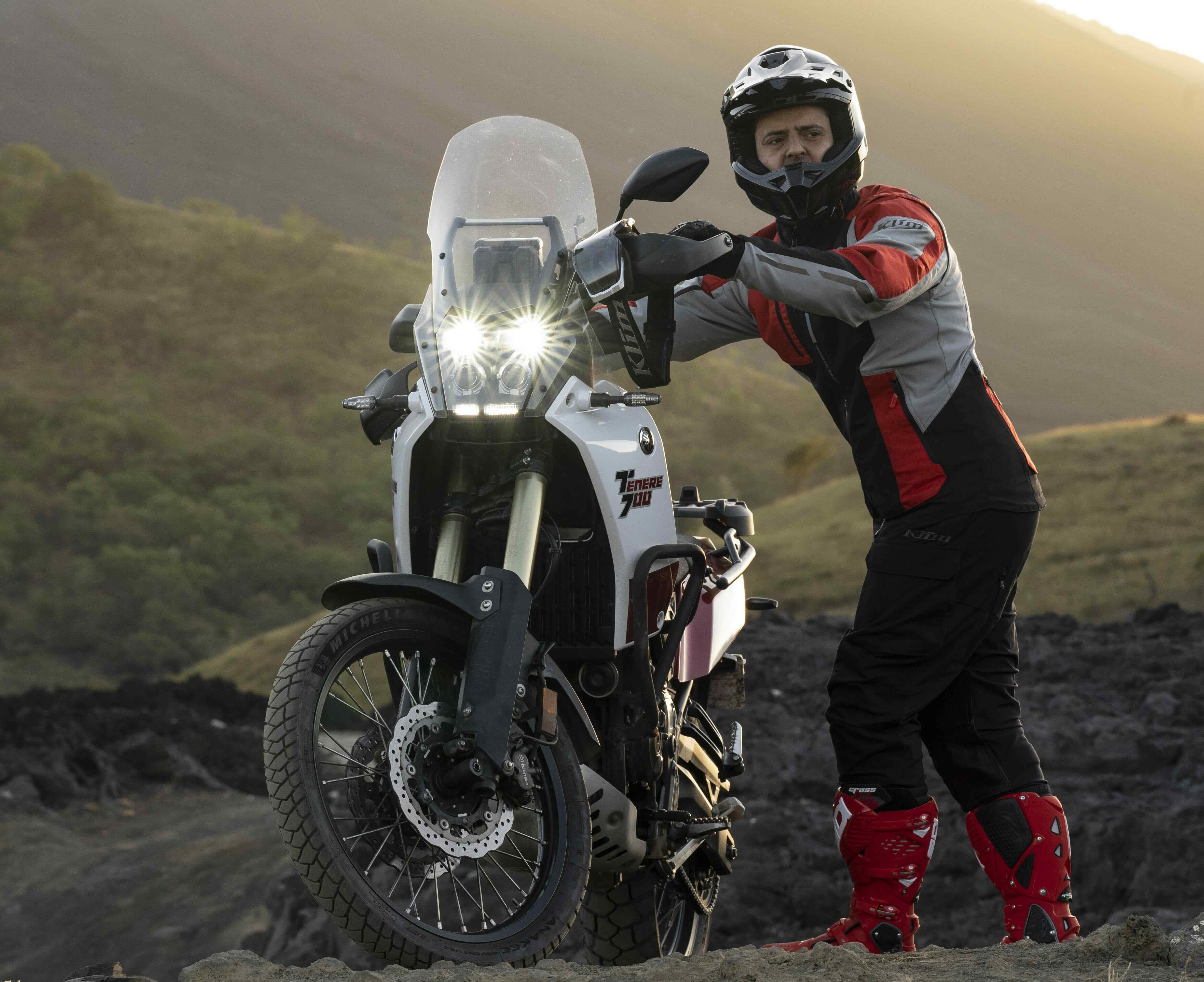 Image of a rider leaning against his motorcycle