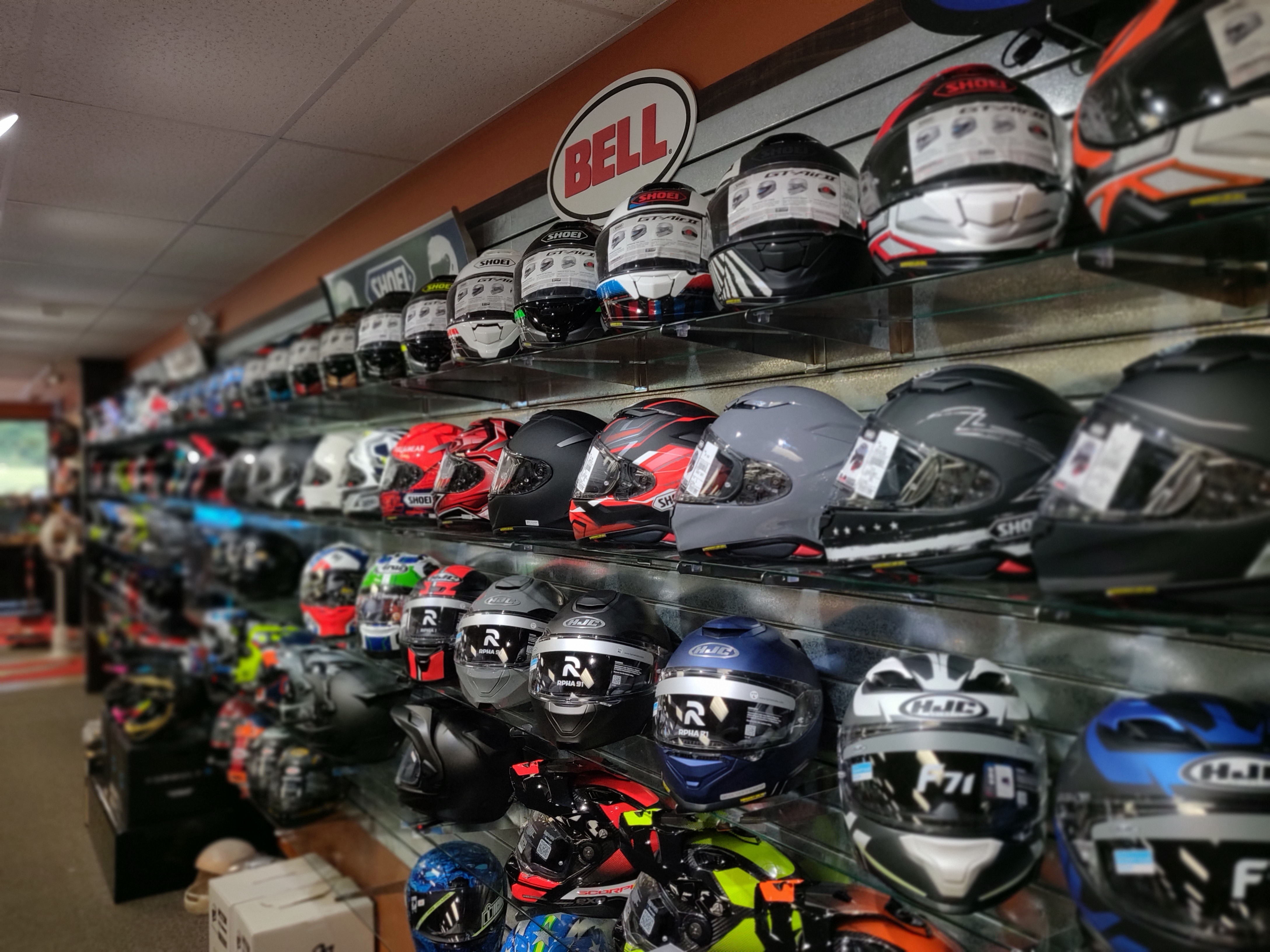 Image of Motorcycle Closeouts in-store helmet wall. 