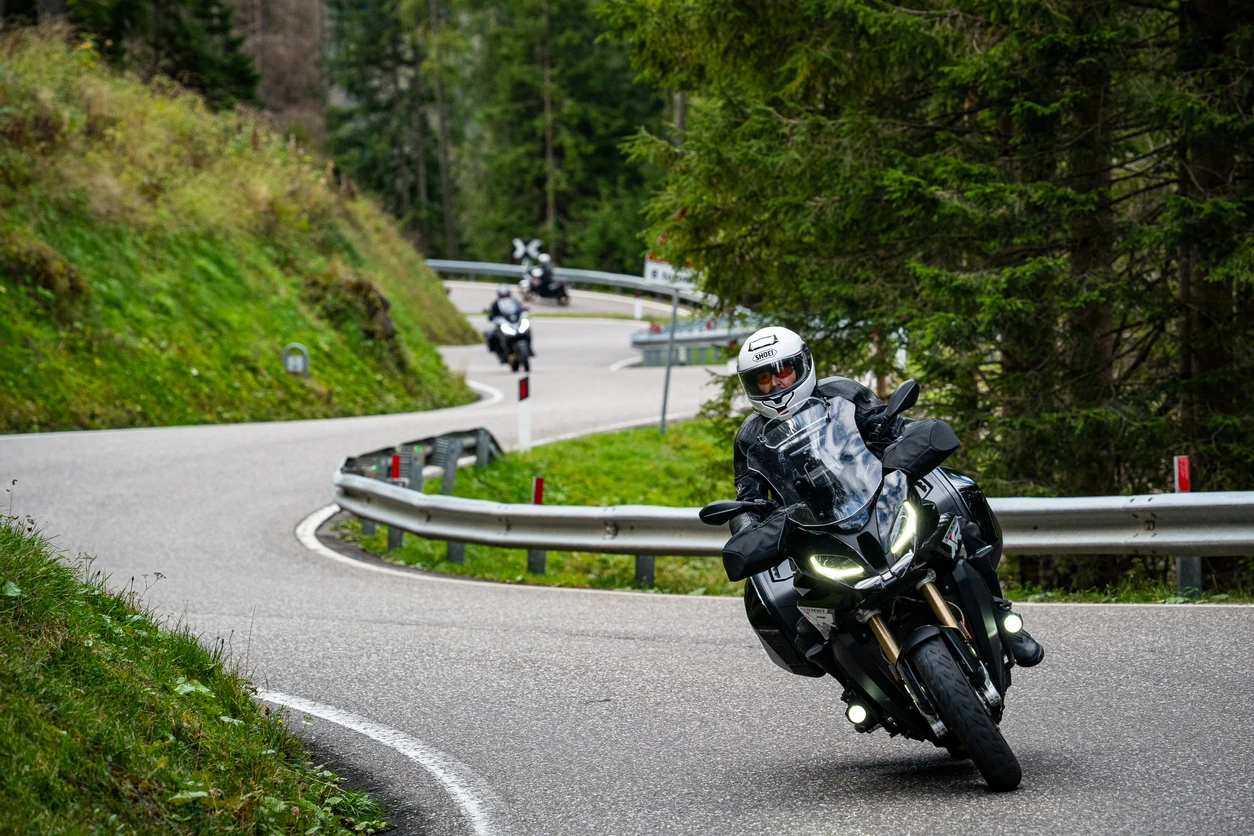 person riding a motorcuycle on a winding road