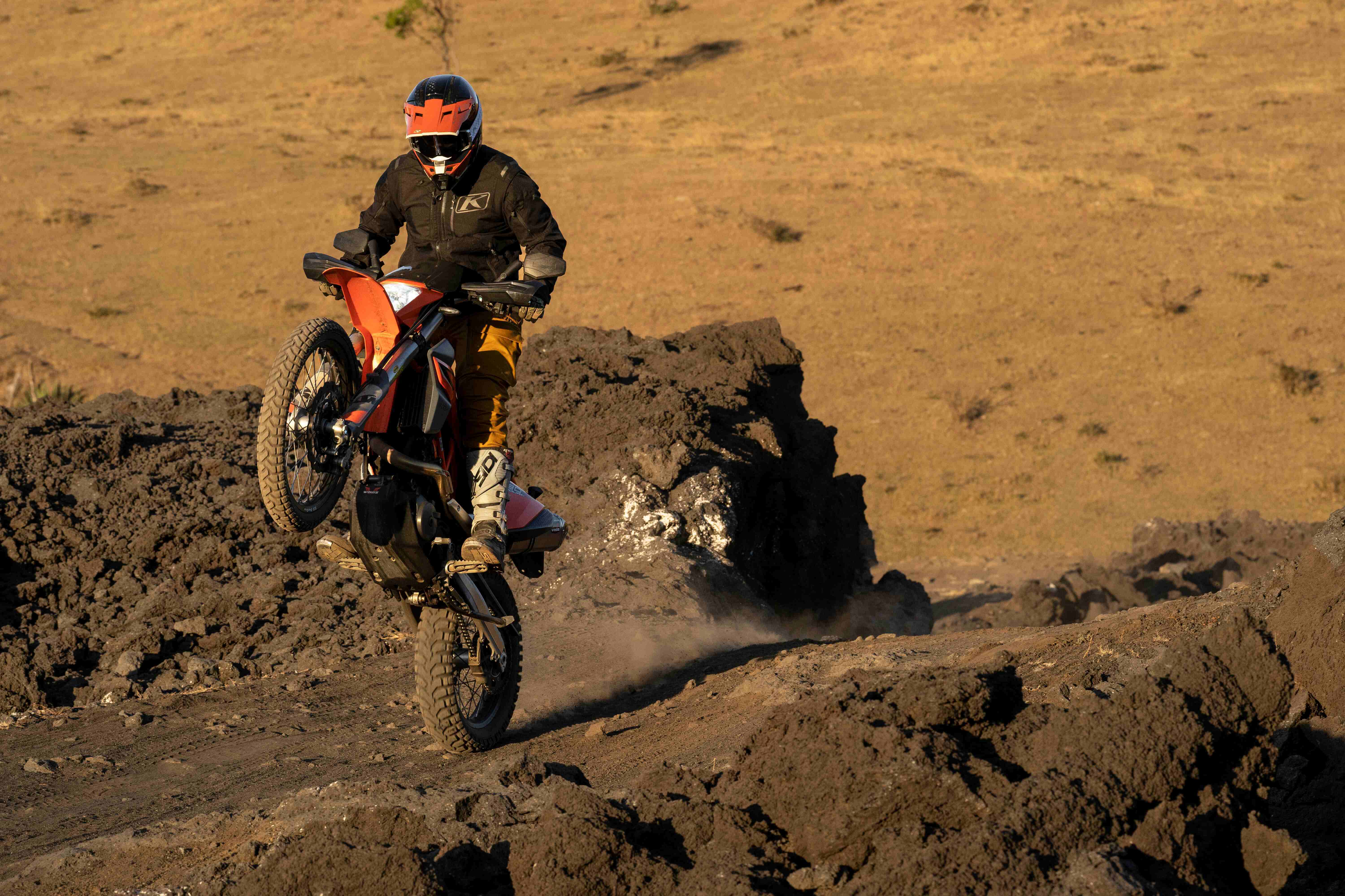 Picture of adventure motorcyclist performing a wheelie