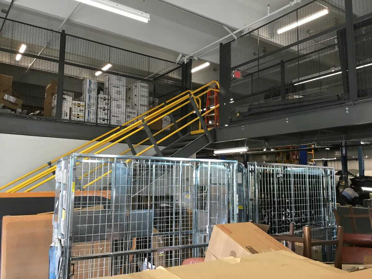 Wire enclosed mezzanine with stair access