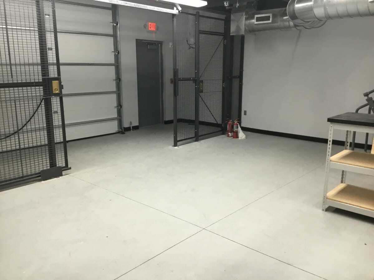Sliding gate cage outside Honda dealership garage