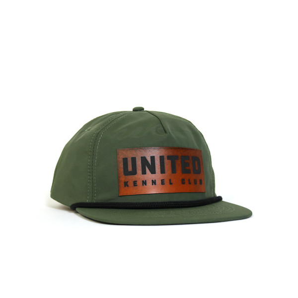 Green ripstop flat bill hat with rope detail, featuring a faux leather United Kennel Club logo patch on the front. Water-resistant, UPF 50+, and made with a recycled plastic bill. Green ripstop flat bill hat with rope detail, featuring a faux leather United Kennel Club logo patch on the front. Water-resistant, UPF 50+, and made with a recycled plastic bill.
