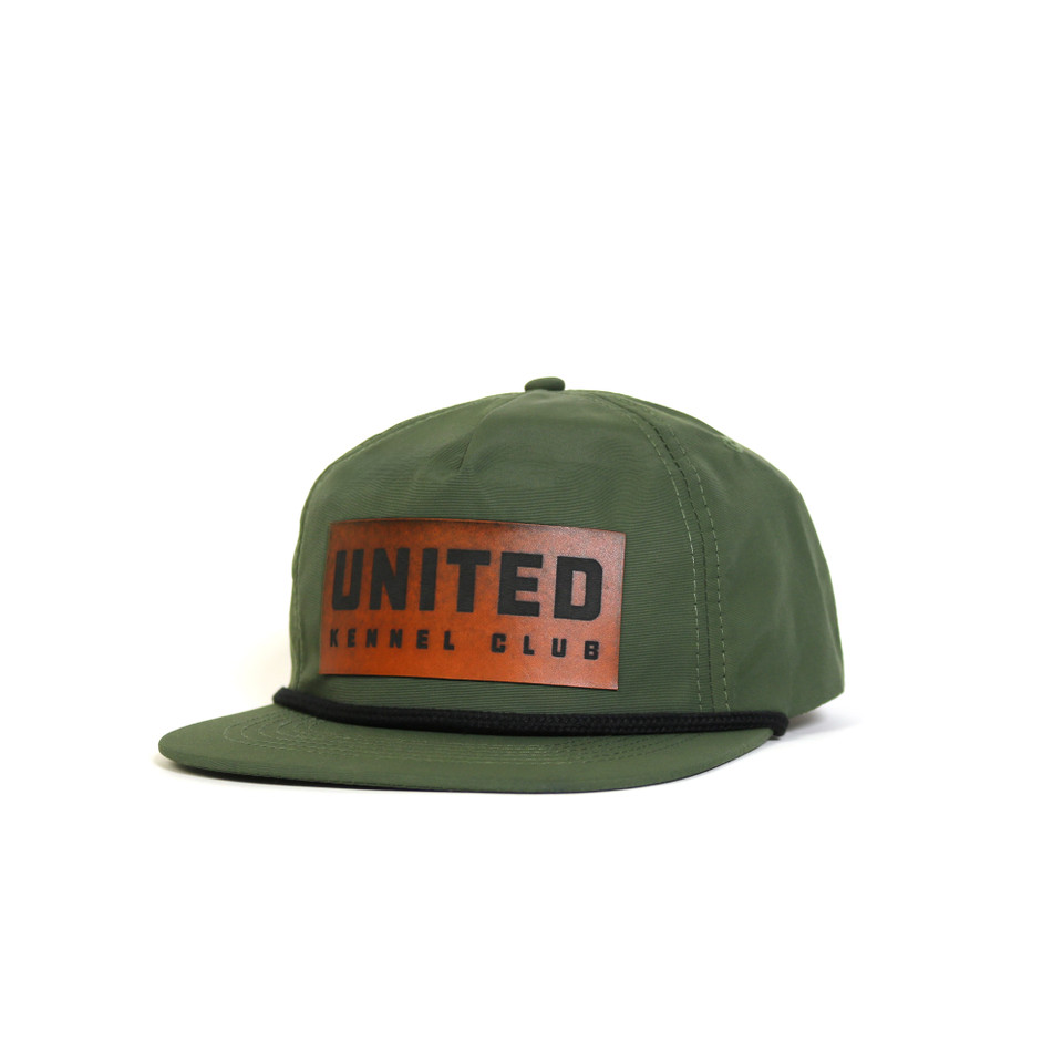 Green ripstop flat bill hat with rope detail, featuring a vegan leather United Kennel Club logo patch on the front. Water-resistant, UPF 50+, and made with a recycled plastic bill.