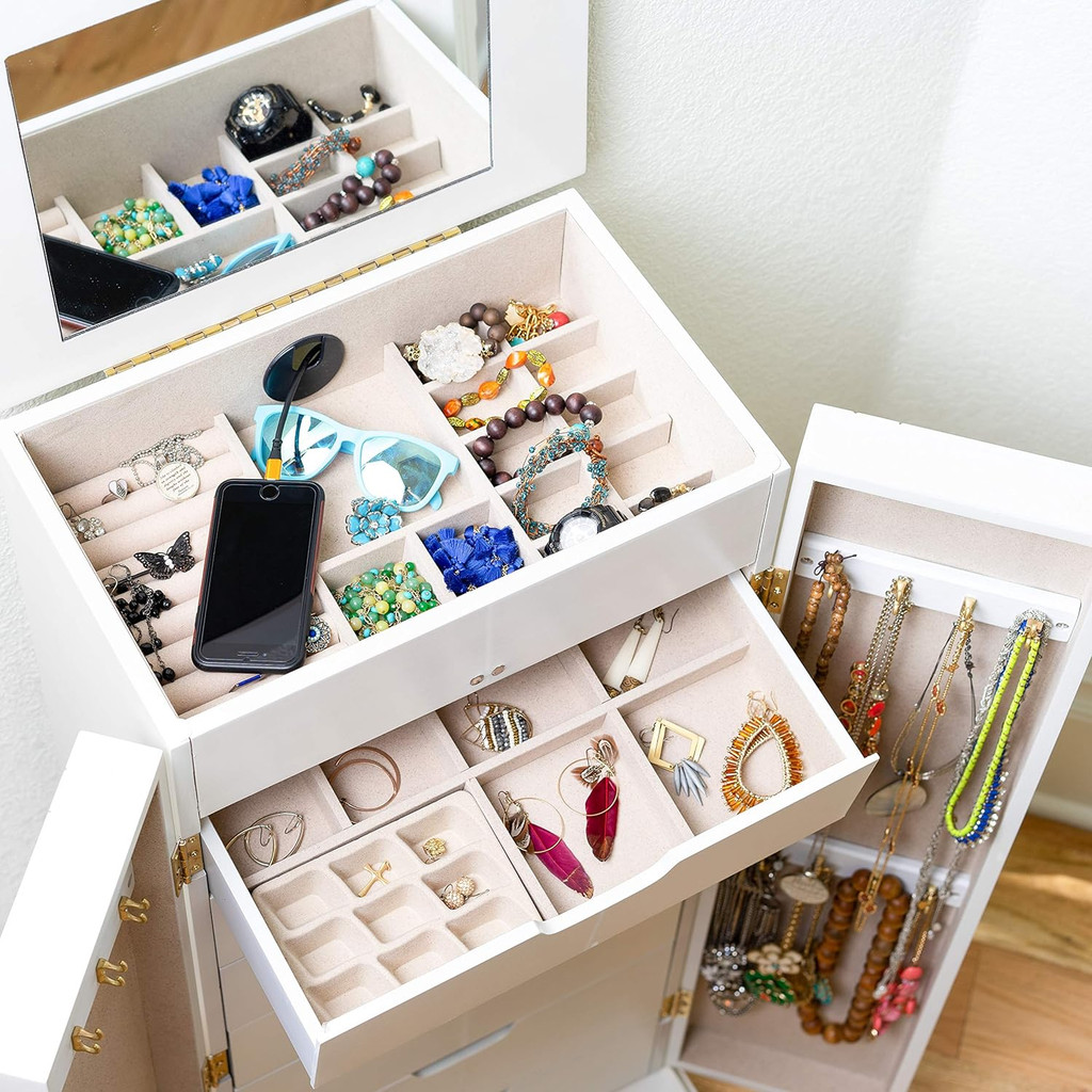 White jewelry armoire with open top compartments showing jewelry and accessories