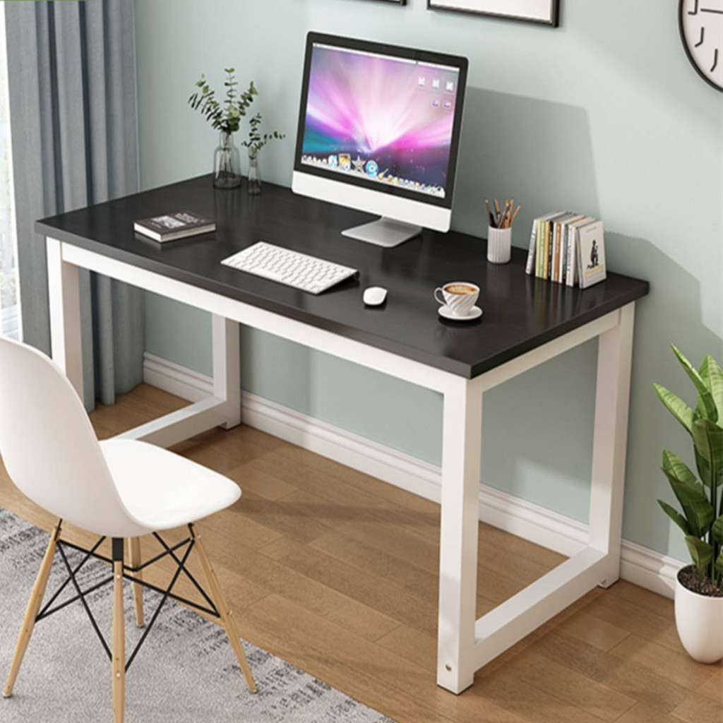 Desk with computer and accessories in a home office setting