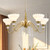 Vintage Chandelier in Brushed Gold Finish with Flower-Shaped White Glass Shades and Hanging Crystal Accents