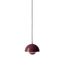 A "Dark Plum" Flowerpot VP10 pendant lamp hangs from a thin cord. The lamp features two hemispherical shades, one larger outer shade and a smaller inner shade, both in a deep purple-red hue.