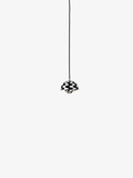 A black and white wave patterned Flowerpot VP10 pendant lamp hangs from a black cord against a white background, featuring a domed outer shade and a smaller inner shade.