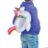 InSpirit Fortnite Pool Party Back Bling, inflatable unicorn pool float with a pink rainbow tail, colorful horn, and cartoonish eyes, worn by a person in a blue hoodie and jeans.