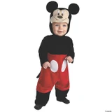 Disguise Mickey Deluxe Toddler Costume, a young child dressed in a Mickey Mouse themed costume with a headpiece featuring Mickey Mouse's face and large ears, a black long-sleeve top, red pants with white oval patches, and black shoes.