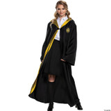 Disguise Harry Potter Hogwarts Deluxe Robe Adult, a woman wearing a black robe with Hogwarts crest, a white shirt, and a yellow-lined hood, resembling Harry Potter from the Harry Potter series.