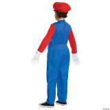 Disguise Super Mario Bros.™ Mario Deluxe Costume -Child, front view of boy wearing bright blue jumpsuit with red long sleeves, red Mario hat, white gloves, and black shoes, dressed as Mario from Super Mario Bros.