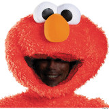 Disguise Elmo Plush Prestige Costume - Adult, a person wearing a large fluffy red Elmo plush mask with big eyes, an orange nose, and a wide-open mouth revealing a smile.