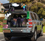 Disguise Minecraft Treat Your Trunk Kit, Halloween themed car decoration with pixelated Minecraft characters and items like creeper, pig, skeleton, TNT, and Steve on the open trunk of a silver SUV.