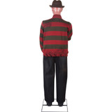 Gemmy Freddy Krueger Life-Size Animatronic, life-sized Freddy Krueger figure from the horror movie franchise, featuring a creepy face, signature red and green striped sweater, fedora hat, and tattered pants.