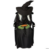 Morris Sitting Witch Animated, a spooky Halloween decoration featuring a seated witch with a large crooked hat, long white hair, green hands, and a black gown, holding a bowl of colorful candy.