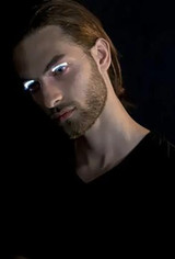 Fantasy Costumes LED Eyelashes, a man wearing illuminated eyelash accessories in a dark setting.