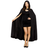 Fun World Cape Hooded Halloween Costume for Adults-Black, female model wearing a black hooded cape costume with a dress and heels, suitable for Halloween parties.