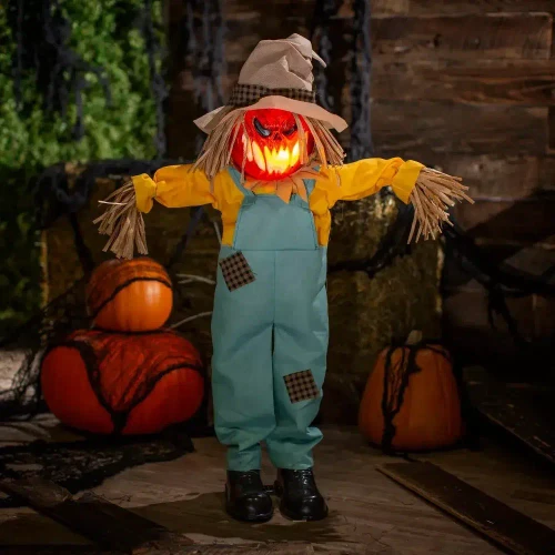 Product A Holiday Company Light-Up Standing Sonic Scarecrow, Halloween decoration with glowing pumpkin head, straw hair, scarecrow hat, yellow shirt, blue overalls, and black boots, measuring 35 1/2 inches tall.