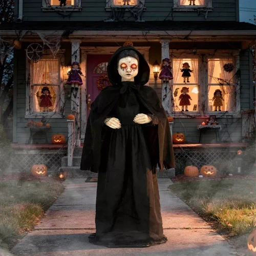 Morris Animated 5 FT Light-Up LED Standing Doll with Moving Head & Eyes, Halloween decoration featuring a spooky doll in a black hooded cloak with glowing eyes in front of a haunted house decorated for Halloween.