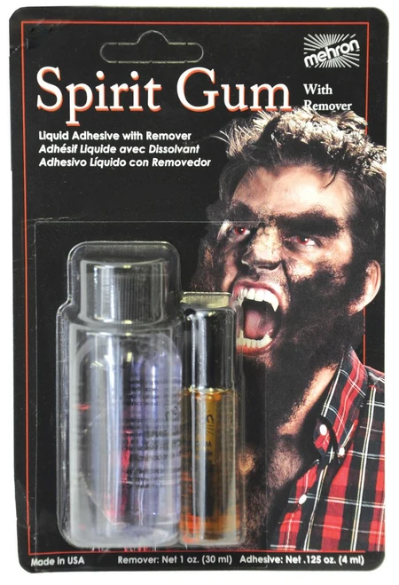 Mehron Spirit Gum & Remover, product packaging with a person with theatrical makeup and facial hair, including a small bottle of liquid adhesive and remover in a blister pack.