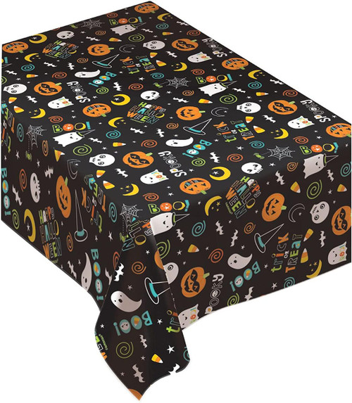 Amscan Halloween Table Cover, festive black table cover decorated with colorful Halloween-themed graphics such as pumpkins, ghosts, bats, spiders, and 'Happy Halloween' text.