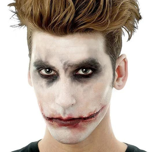 Woochie The Jokester Woochie Appliance, makeup makeup with a sinister clown smile and dark eye makeup.