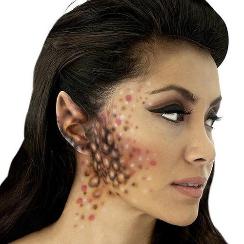 Woochie Space Ear Tips Latex Appliance (Small), close-up image showing a woman with theatrical makeup applying special effects latex ear tips for cosplay or costume use.