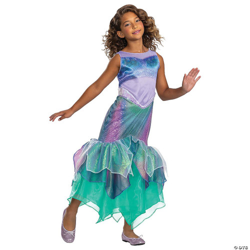 Disguise Little Mermaid Ariel Deluxe Child Costume, girl dressed in colorful mermaid costume with iridescent scales, purple top, and ruffled green tail, posing with a smile.