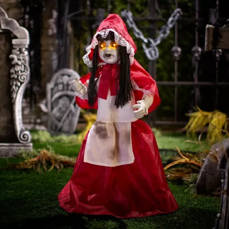 Product A Holiday Company Animated Light-Up 35' Standing Girl with Sound Halloween Decoration, creepy Halloween figure with glowing eyes, red hooded dress, white apron, and long black hair in a spooky outdoor setting.