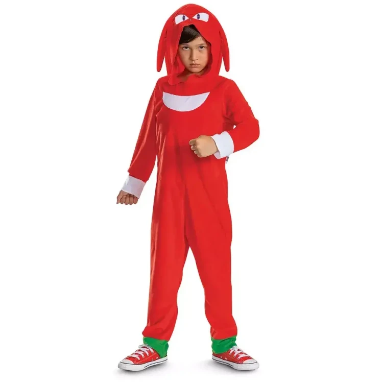 Disguise Sonic the Hedgehog Knuckles Hooded Jumpsuit Costume - Child, a young boy wearing a red hooded jumpsuit with Sonic the Hedgehog faces on the hood and a large white smile on the chest, complemented by red sneakers with white laces and green accents at the ankles.