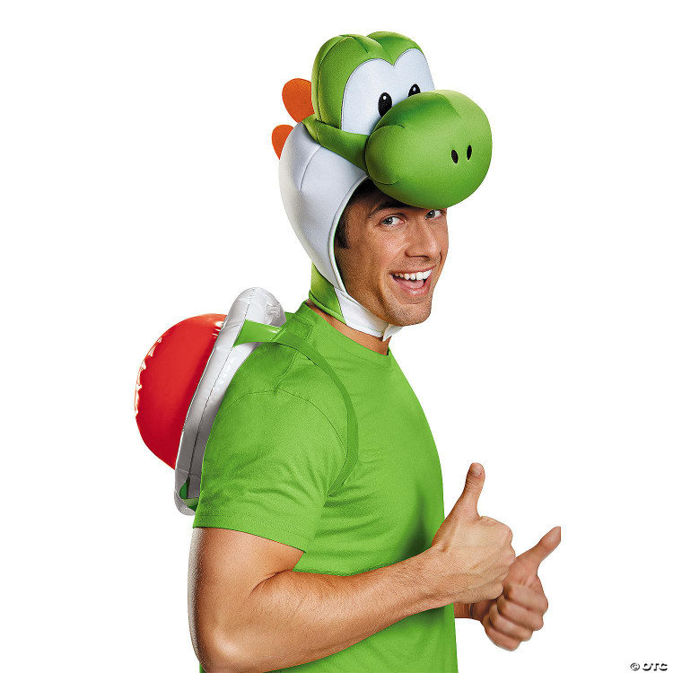 Disguise Yoshi Costume Super Mario Bros.™ Kit - Adult, a man wearing a green shirt with a Yoshi mask on his head, and a red and white backpack resembling Yoshi's shell, giving a thumbs up.