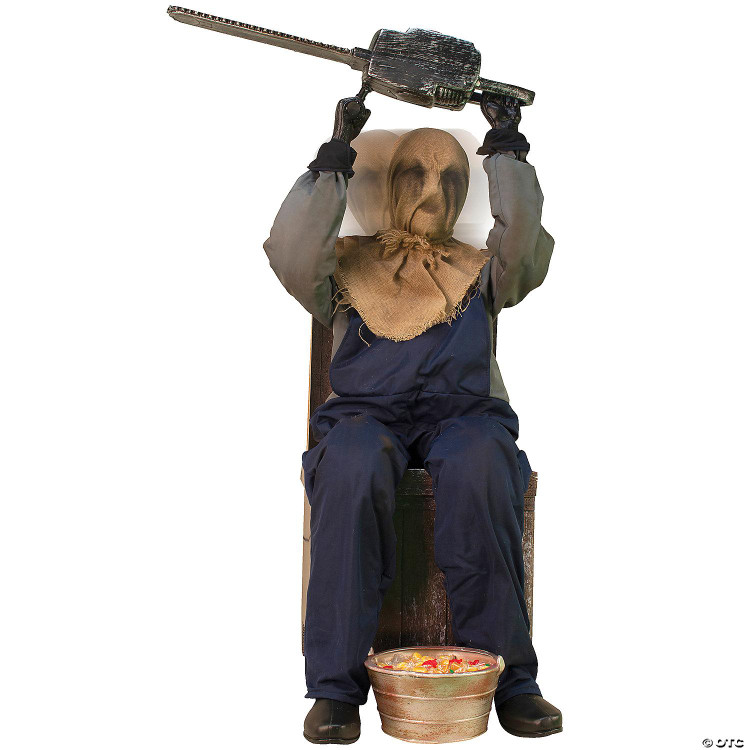Morris Chainsaw Greeter Animated Prop 45 inches, positioned on a chair with a hooded figure holding a toy chainsaw above its head, including a bowl of candy at its feet for a Halloween or autumn display.