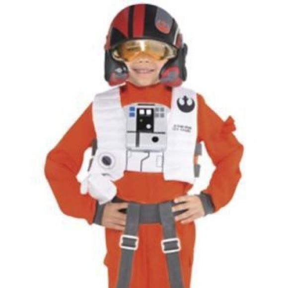 Amscan Star Wars Poe Dameron costume - Child Small, a young boy dressed as Poe Dameron from Star Wars, wearing an orange pilot jumpsuit, a black helmet with red accents, and a white vest with Star Wars-themed details.