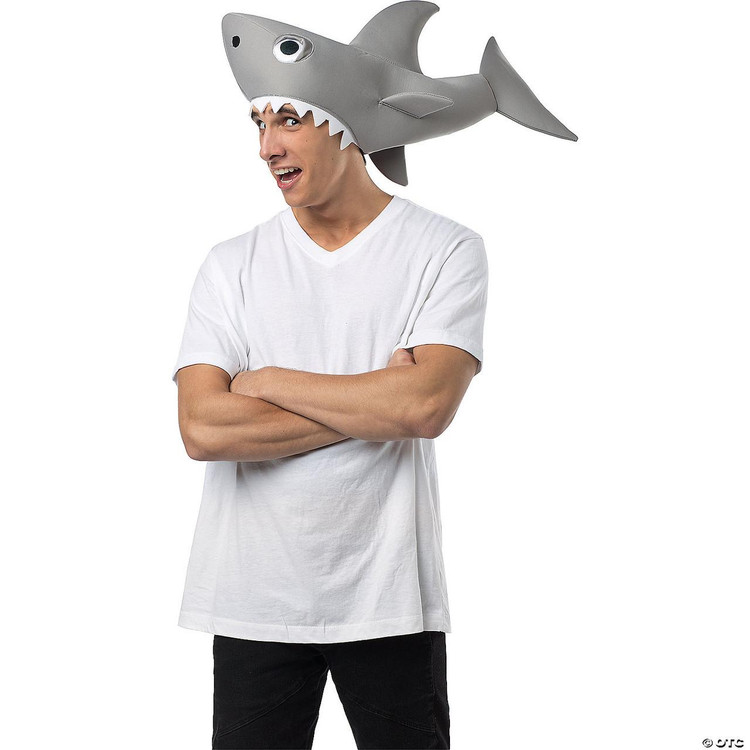 Rasta Imposta Sharknado Man Eating Shark Hat, a novelty costume accessory featuring a large, animated shark head with teeth, worn as a hat on a person with arms crossed and wearing a white t-shirt.
