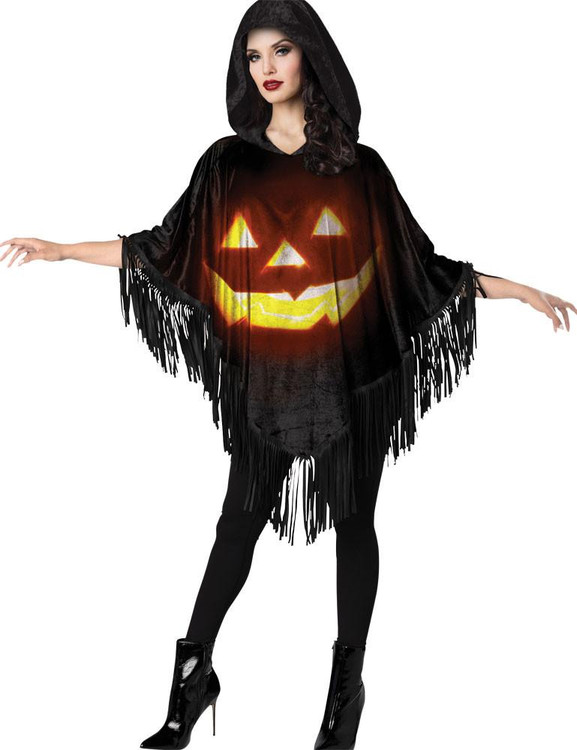 Fun World Poncho Jack-O-Lantern Instant, woman modeling a black Halloween poncho with a glowing jack-o-lantern face, fringed edges, and a hood for festive costume wear.