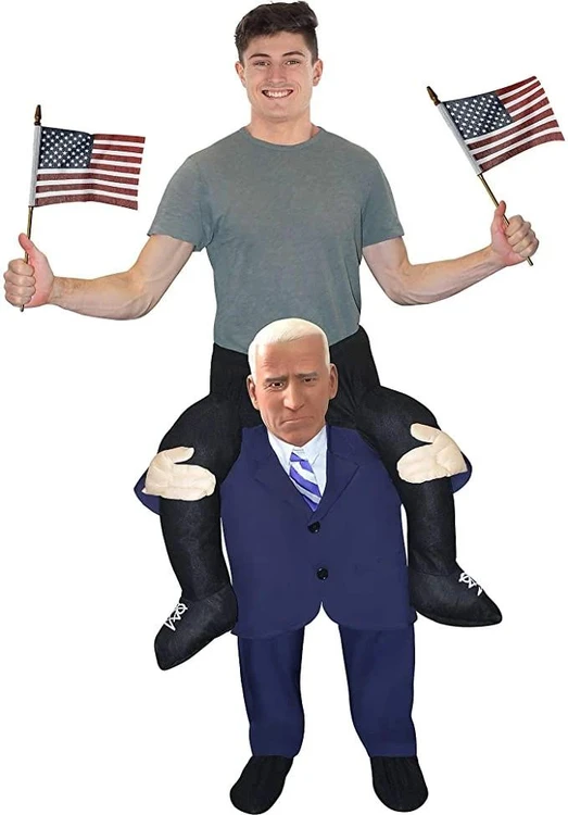 Morphsuits Former VP Piggyback Rider costume, a person wearing a large puppet-like mask of a serious man in a suit carrying a person dressed as a young man with a joyful expression and American flags