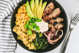 Grilled Pork Tenderloin Bowls with Quinoa, Grilled Corn, Poblanos, Avocado and Spicy Lime Crema