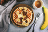 Greek Yogurt Waffles with Bananas, Candied Pecans, Maple Rum Syrup and Whipped Cream