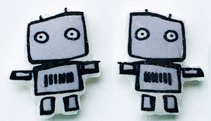 Small handmade robot stud earrings featuring simple gray boxy robot characters with round eyes and outstretched arms on a clean background.
