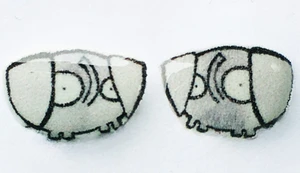 Small handmade elephant stud earrings featuring simple gray elephant shapes with curved trunks and minimal expressive details on a clean background.
