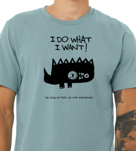 Close-up of spiky cartoon monster illustration with humorous polite rebellion quote on blue tee.