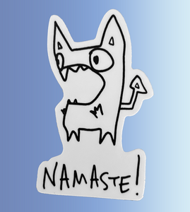 A black and white cartoon monster with pointy ears and an open mouth with the word “Namaste!” written below.
