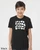Youth wearing black monster graphic tee showing a crowd of quirky monster characters.
