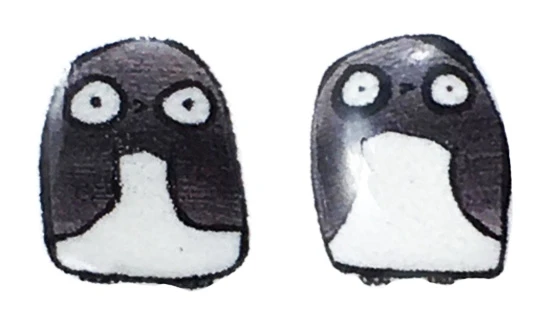 Small handmade penguin stud earrings featuring simple black and white penguin characters with round shapes and wide expressive eyes on a clean background.